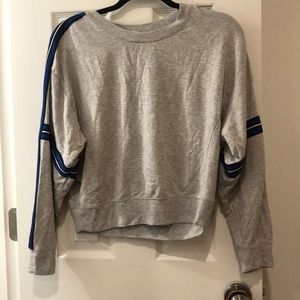 Sweater with blue stripes down arms